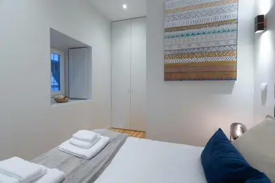 a bedroom with a bed with two towels on it at Swimming Pool Luxury House 2 in Porto
