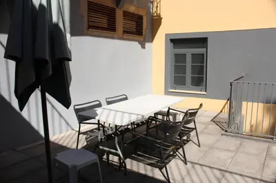 a table and chairs sitting on a patio at 107 Rosario, Guesthouse in Porto