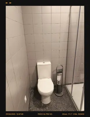 a bathroom with a white toilet in a stall at 107 Rosario, Guesthouse in Porto