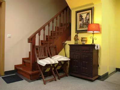 a room with a staircase with a chair and a lamp at 107 Rosario, Guesthouse in Porto