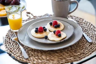 a plate of cookies with fruit on top on a table at Sunset Flat Santa Catarina in Porto