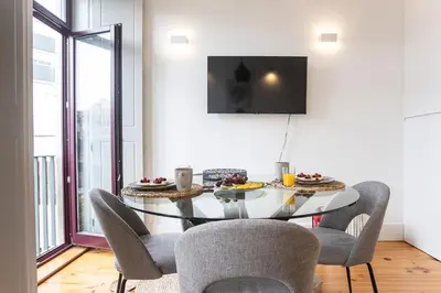 a dining room with a glass table and chairs at Sunset Flat Santa Catarina in Porto