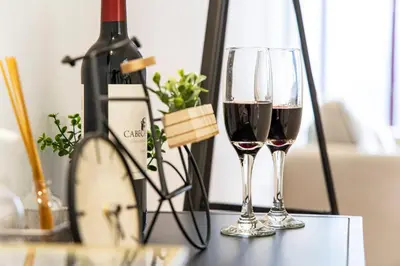 two glasses of red wine next to a bottle of wine at Sunset Flat Santa Catarina in Porto