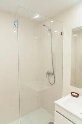a bathroom with a shower with a glass door at Porto Wine Loft Duplex with swimming pool in Vila Nova de Gaia