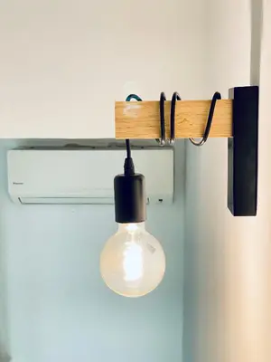 a light hanging from a rail with a light bulb at Porto Wine Loft Duplex with swimming pool in Vila Nova de Gaia