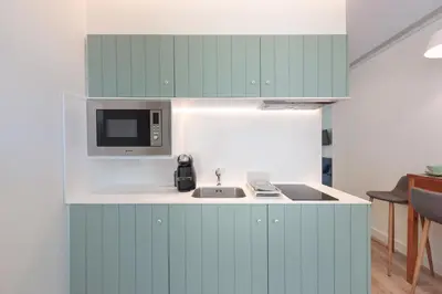 a kitchen with a sink and a microwave at 7 Bridges Estúdios- Porto-houses and suites in Porto