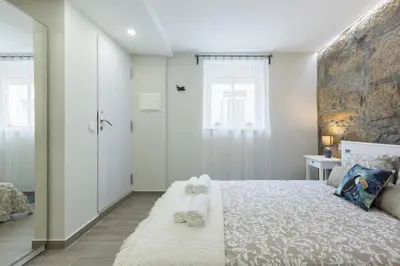 a bedroom with a large bed with towels on it at OportoHost Cozy Studios in Porto