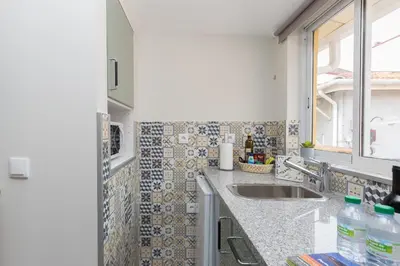 a kitchen with a sink and a window at OportoHost Cozy Studios in Porto