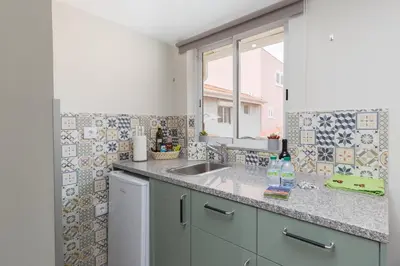 a kitchen counter with a sink and a window at OportoHost Cozy Studios in Porto