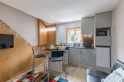 a kitchen with a table and chairs in a room at OportoHost Campanhã in Porto