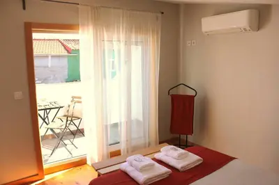 a bedroom with two towels on a bed in front of a window at OportoHost Campanhã in Porto