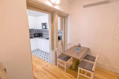 a kitchen and dining room with a table and chairs at Janelas de São Bento 3 by Porto City Hosts in Porto