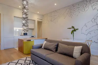 a living room with a couch and a table at BOUTIQUE Rentals- Art & Charm Apt w/ balcony & garage in Porto