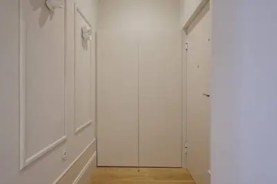 a hallway with white cabinets and a mirror at BOUTIQUE Rentals- Art & Charm Apt w/ balcony & garage in Porto