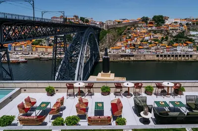 a room with chairs and a table and the eiffel tower at Vincci Ponte de Ferro in Vila Nova de Gaia