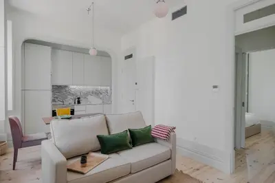 a living room with a couch and a table at Charming Camões Apartment in Porto with AC & Wi-Fi in Porto
