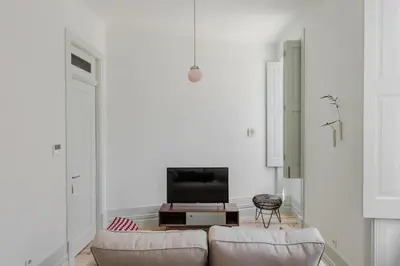 a living room with a couch and a tv at Charming Camões Apartment in Porto with AC & Wi-Fi in Porto