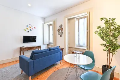 a kitchen with white cabinets and a counter top at ON Apartments - Garden View in Porto