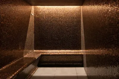 a dark room with a shower with a brick wall at Eurostars Aliados in Porto