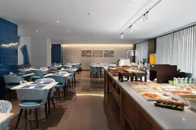 a restaurant with tables and chairs and a buffet at Eurostars Aliados in Porto