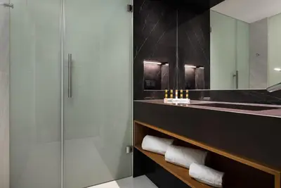 a bathroom with a sink and a mirror at Eurostars Aliados in Porto