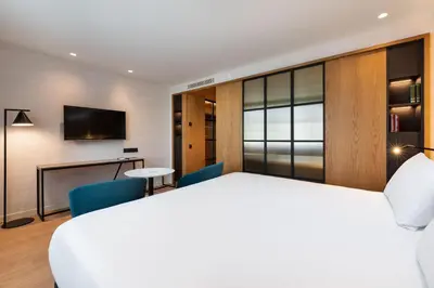 a hotel room with a bed and a tv at Eurostars Aliados in Porto