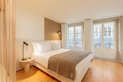 a bedroom with a bed and a large window at YOUROPO - Flores in Porto