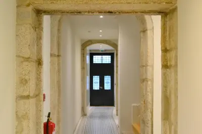 a hallway with a black door in a building at Porto Pool Spot in Porto