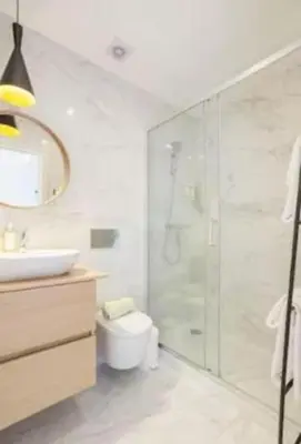 a bathroom with a shower and a toilet and a sink at Porto Pool Spot in Porto