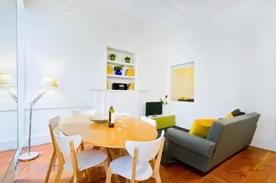 a living room with a table and a couch at Charming Historic 31 Janeiro Street in Porto