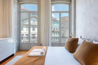 a bedroom with a bed and a large window at LovelyStay - Deluxe 2BR Duplex with Splendid View in Porto