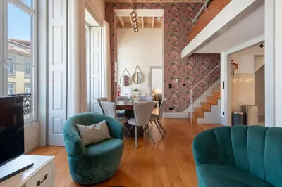 a living room with a table and chairs at LovelyStay - Deluxe 2BR Duplex with Splendid View in Porto