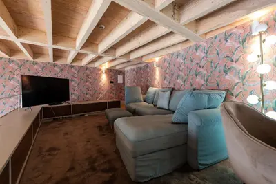 a living room with a couch and a flat screen tv at LovelyStay - Deluxe 2BR Duplex with Splendid View in Porto