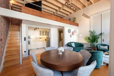 a living room with a wooden table and chairs at LovelyStay - Deluxe 2BR Duplex with Splendid View in Porto