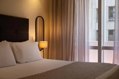 a bedroom with a bed and a large window at Bolhão Apartment in Porto