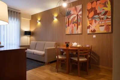 a living room with a table and a couch at Bolhão Apartment in Porto