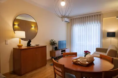 a living room with a table and a mirror at Bolhão Apartment in Porto