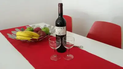 a bottle of wine and two glasses on a table at O´Porto Torrinha Flat in Porto