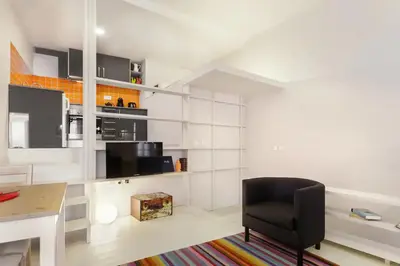 a living room with a desk and a chair at O´Porto Outeiro Flat in Porto