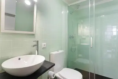 a bathroom with a sink and a toilet and a shower at O´Porto Outeiro Flat in Porto