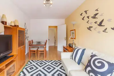 a living room with a white couch and a tv at O´Porto Fontinha Flat in Porto