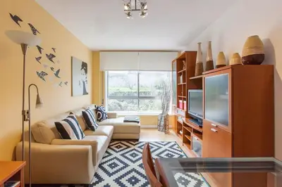 a living room with a couch and a tv at O´Porto Fontinha Flat in Porto