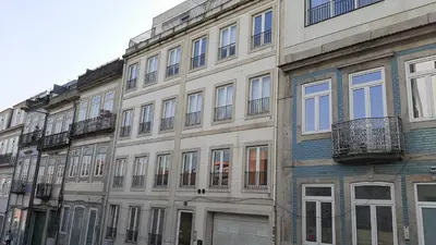 a large building with many windows on a street at O´Porto Fontainhas Flat in Porto