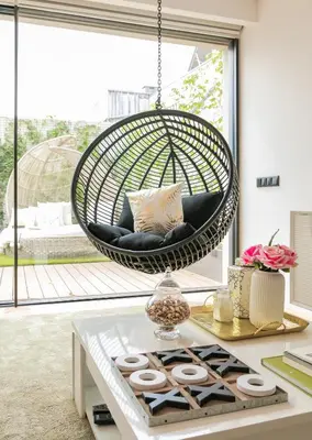 a woman sitting in a swing in a living room at Oporto Diamond Luxe & Terrace in Porto