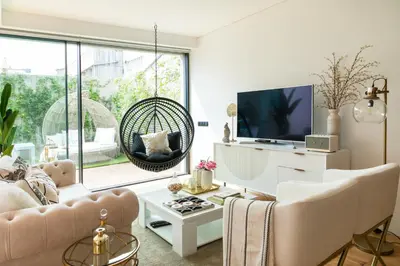 a hanging chair in a room with a table at Oporto Diamond Luxe & Terrace in Porto