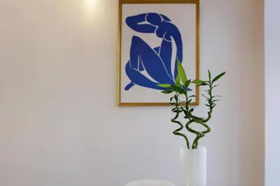 a plant in a vase on a table with a picture at Artury Porto in Porto