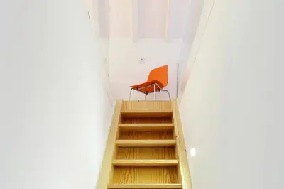 an orange chair sitting on top of a flight of stairs at Artury Porto in Porto