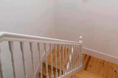 a white staircase with white walls and wooden floors at Artury Porto in Porto