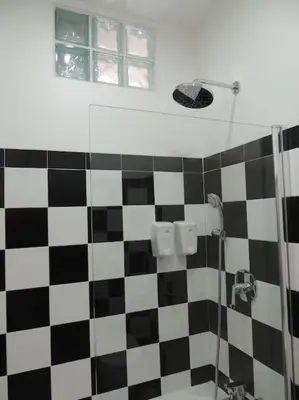 a bathroom with a black and white checkered shower at Rendez Vous Porto II in Porto