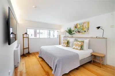 a white bedroom with a bed and a window at Villa Almada - Amazing City Centre Villa with Private Pool in Porto